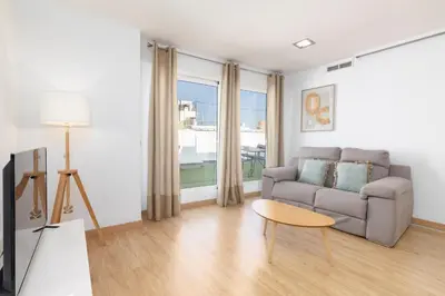 a living room with a couch and a table at Travel Habitat - Ático Centro in Valencia