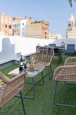 a group of chairs and a table on a roof at Travel Habitat - Ático Centro in Valencia