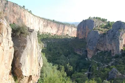 arial view of a canyon with cliffs and trees at CASICA TIA CARMEN in Chulilla