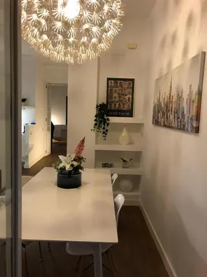 a dining room with a table and a chandelier at Impresionante apartamento en Ruzafa al lado del mercado in Valencia