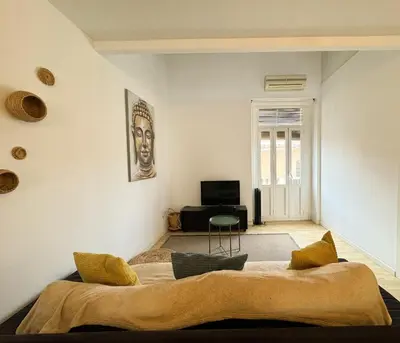 a bedroom with a large bed in a room at Duplex al lado de los Jardines del Turia in Valencia