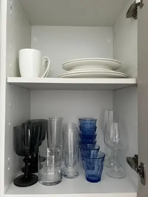 a bunch of glass items sitting on a shelf at Apartment near the port, City Of Arts and 10min to the beach in Valencia