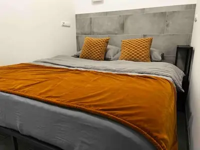a large bed with two pillows on top of it at Apartment near the port, City Of Arts and 10min to the beach in Valencia