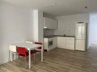 a kitchen with a table and chairs and a refrigerator at Cozy flat in La Petxina_A in Valencia