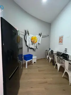 a room with chairs and a cow on the wall at Beach & Arts Hostel Valencia in Valencia