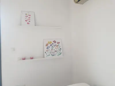 a white room with two pictures on a shelf at aeropuerto loft polígono in Manises