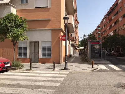 an empty city street with a phone booth next to a building at Apartamento equipado playa Valencia OnesDeMar in Valencia