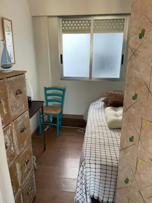 a bedroom with a bed and a desk and a window at UIM Mediterraneo ATICO San Pedro Wifi in Puerto de Sagunto