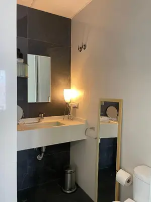 a bathroom with a sink and a mirror at UIM Mediterraneo ATICO San Pedro Wifi in Puerto de Sagunto