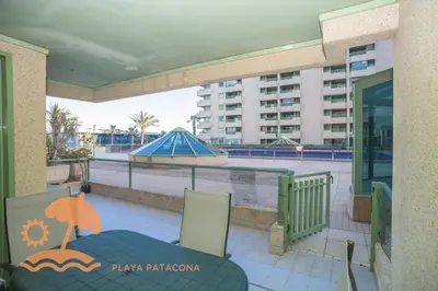 a balcony with a chair and a view of a building at Patacona Green Holiday in Valencia