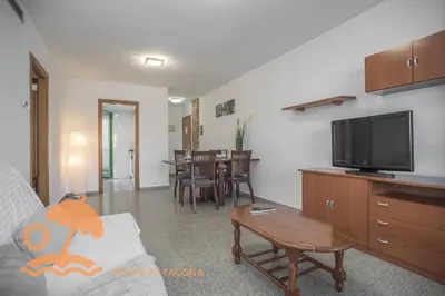 a living room with a couch and a flat screen tv at Patacona Green Holiday in Valencia
