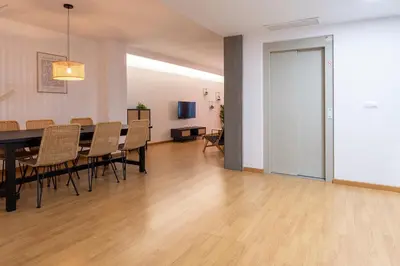 a dining room and living room with a table and chairs at Moontels Paseo de Ruzafa in Valencia