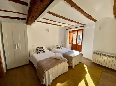 a bedroom with two beds in a room at VILLA SOL Casa con cueva privada y vistas a la Iglesia in Requena