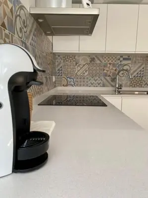 a black faucet in a kitchen with a sink at VILLA SOL Casa con cueva privada y vistas a la Iglesia in Requena