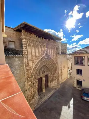 an old stone building with a large doorway at VILLA SOL Casa con cueva privada y vistas a la Iglesia in Requena