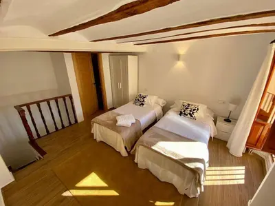 a bedroom with two beds in a room at VILLA SOL Casa con cueva privada y vistas a la Iglesia in Requena