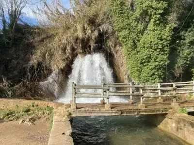a bridge over water with a waterfall in the background at CASA BAUTISTA - ROTGLÀ in Rotglá y Corbera