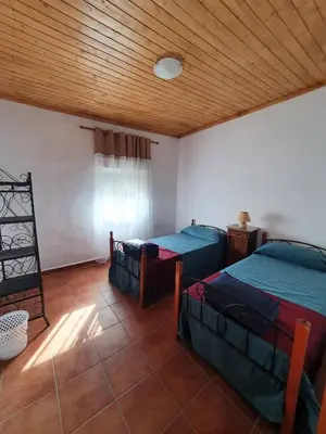 a bedroom with two beds and a wooden ceiling at CASA BAUTISTA - ROTGLÀ in Rotglá y Corbera