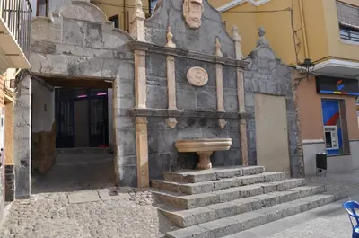a building with a fountain on the side of it at CASA PORTALICO in Jérica