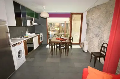 a kitchen and dining room with a table and chairs at CASA PORTALICO in Jérica