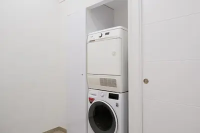 a washer and dryer in a white room at Studio Sorolla - Spacious studio near Valencia's beaches in Valencia