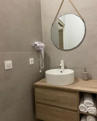 a bathroom with a sink and a mirror at Apartamentos Casa Anselmo EL TERRAO in Losa del Obispo