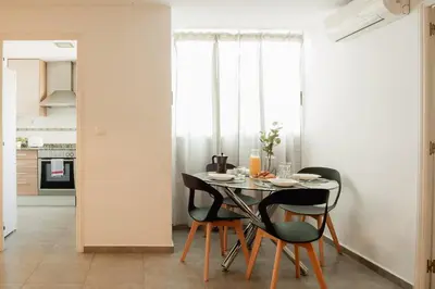 a kitchen and dining room with a table and chairs at Apartamentos FV Flats Valencia - Mestalla 7 in Valencia