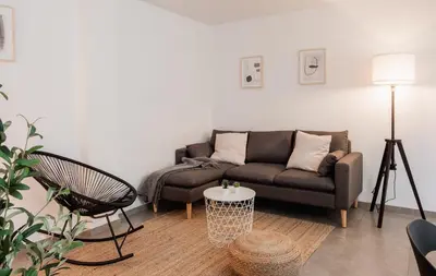 a living room with a couch and a chair at Apartamentos FV Flats Valencia - Mestalla 7 in Valencia