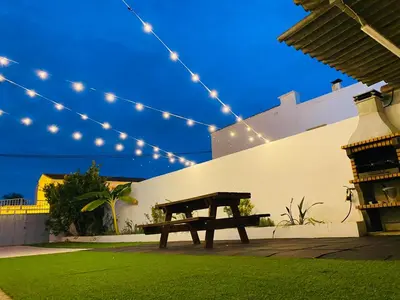 a picnic table in a yard with string lights at Casa Mayor in Tous
