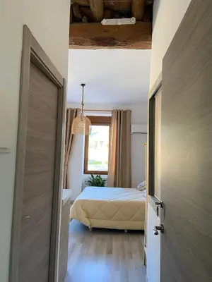 a bedroom with a bed and a window and a door at Apartamento Casa Anselmo La cambra in Losa del Obispo