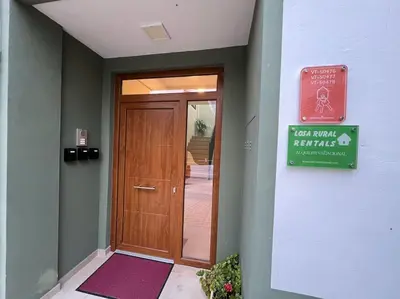 a door in a building with a sign next to it at Apartamentos LOSA RURAL in Losa del Obispo
