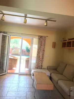 a living room with a couch and a table at Casa buganvilla in Almarda