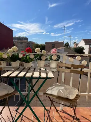 a table with flowers on top of a roof at La casita de Jimena in Valencia