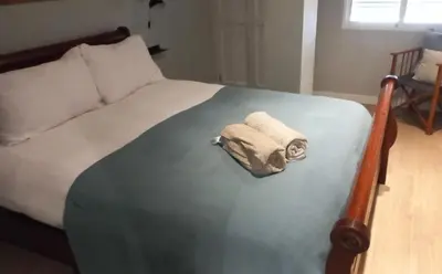a bed with a towel sitting on top of it at Classic City Apartment in Valencia