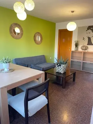 a living room with a couch and a table at UIM Mediterraneo Diagonal 16 Wfi in Puerto de Sagunto