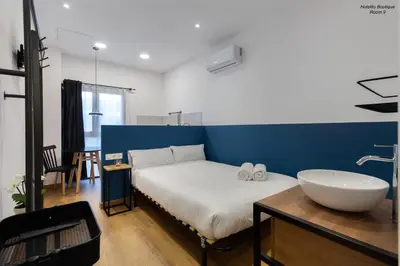 a bedroom with a white bed and a sink at Hotelito Boutique Valencia Estación in Valencia