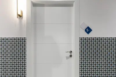 a door in a bathroom with a tile wall at Hotelito Boutique Valencia Estación in Valencia