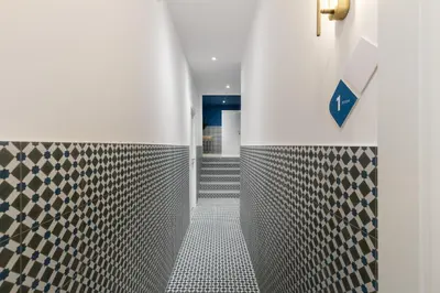 a hallway with a tiled floor and a staircase at Hotelito Boutique Valencia Estación in Valencia