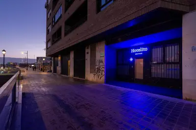 a building with a blue sign on the side of it at Hotelito Boutique Valencia Estación in Valencia