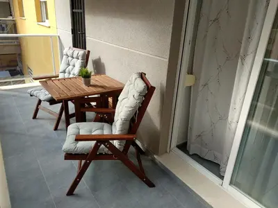 a wooden table and chairs on a balcony at Apartamento acogedor en playa de Moncofa in Moncófar