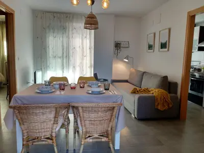 a living room with a table with chairs and a couch at Apartamento acogedor en playa de Moncofa in Moncófar