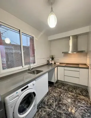 a kitchen with a washer and a sink and a washing machine at UIM Mediterraneo Juana Wifi in Puerto de Sagunto
