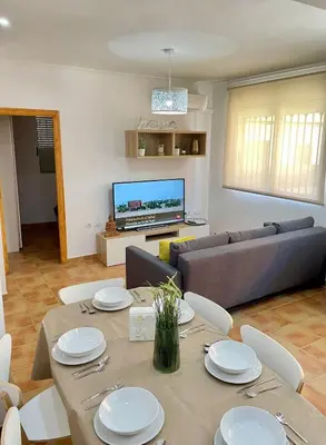 a living room with a table and a couch at UIM Mediterraneo PB Plomo 2 Wifi in Puerto de Sagunto