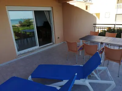 a patio with a table and chairs and a balcony at Oasis Solo Familias Serviplaya in Casas Las Basas