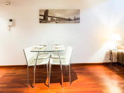 a glass table and chairs in a room with a painting at Total Valencia (Leisure & Culture) in Valencia