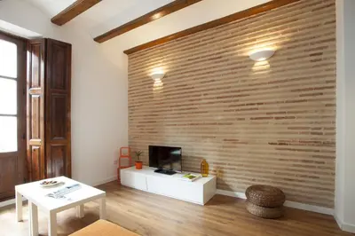 a living room with a large brick wall at Singular Apartments Station in Valencia