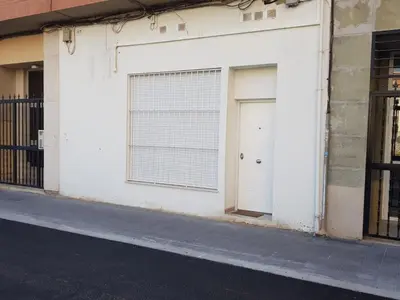 a white garage door with a window on a building at Studio Picasso near the port and beach in Valencia
