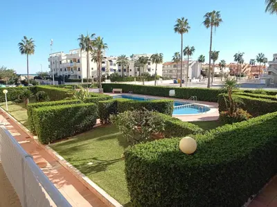 a white table and chairs on a balcony at Las Olas Solo Familias Serviplaya in Casas Las Basas