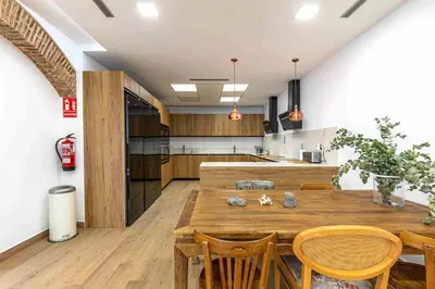 a kitchen with a large wooden table and chairs at Residencia Demar in Godella