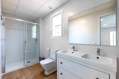 a bathroom with a toilet and a sink and a shower at Residencia Demar in Godella